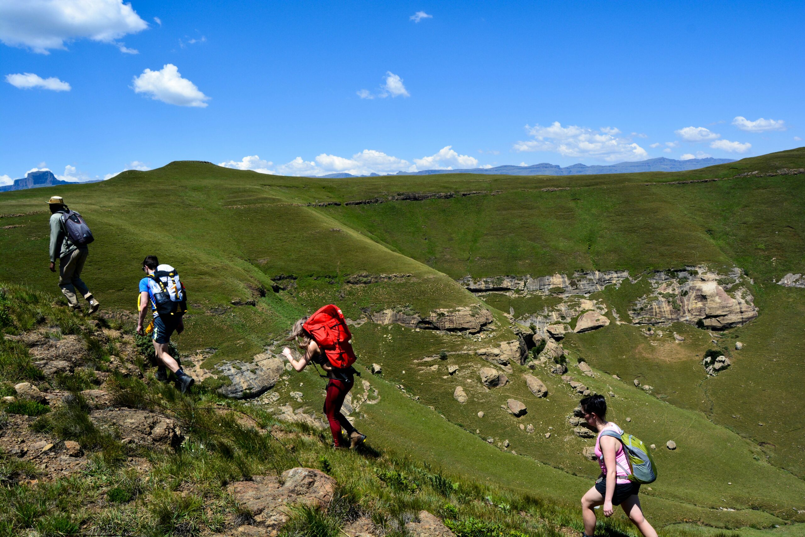 dannii-coughlan-tk4OYV3L8Ts-unsplash Four hikers in Drakensberg, South Africa